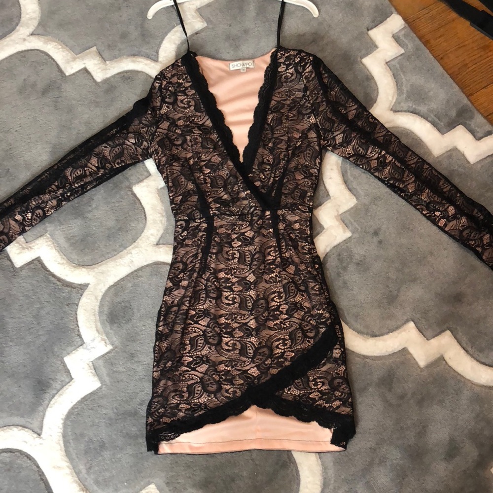 Nude under black lace low cut dress